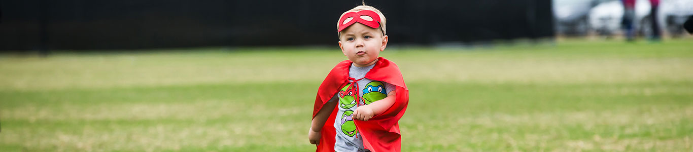 little boy in super hero costume